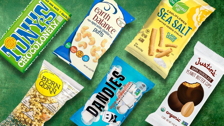 a collection of vegan snacks on a green background