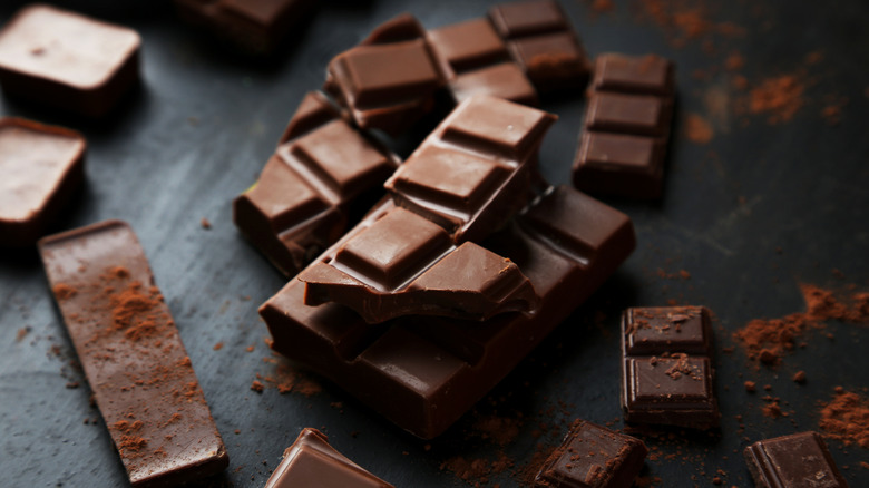 Squares of dark chocolate or a dark background