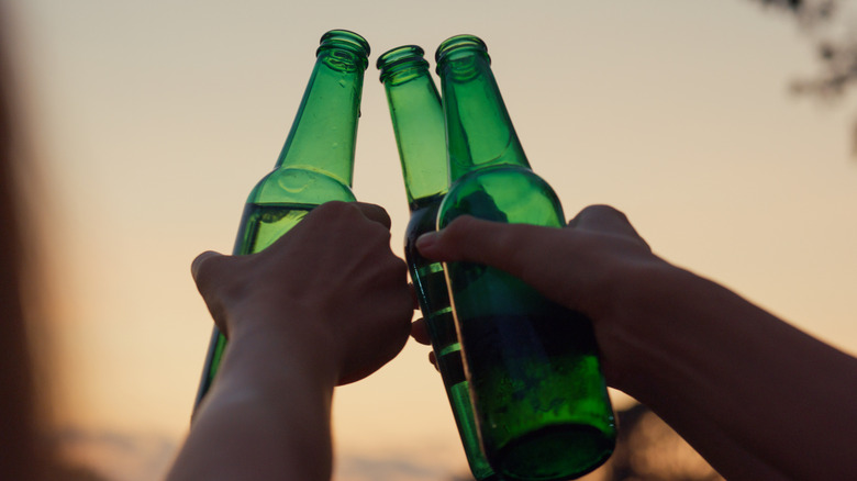 hands cheers beers together